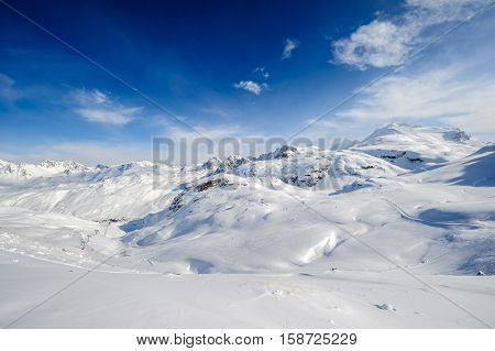 Alpine winter mountain landscape. French Alps covered with snow in sunny day. Val-d'Isere, France