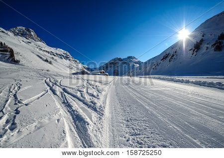 Alpine winter mountain landscape. French Alps covered with snow in sunny day. Val-d'Isere, France