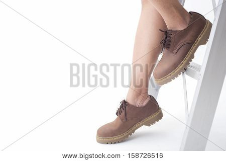 women legs in leather boots fashion side view isolated on the white background.