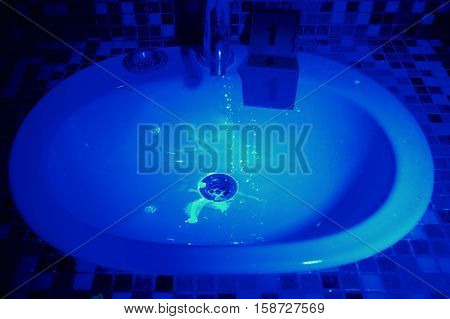 Wash basin with stains under UV light