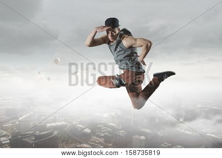 B-boy performing some moves . Mixed media