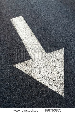White arrow on asphalt road traffic sign marking on roadway