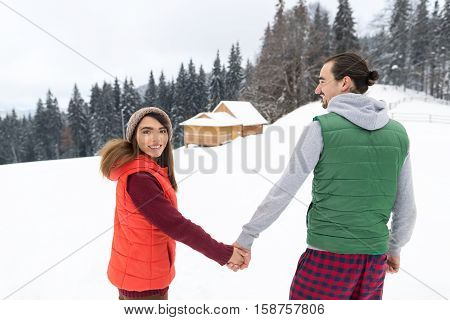 Young Couple Snowy Village Wooden Country House Man And Woman Winter Snow Resort Cottage Holiday Vacation