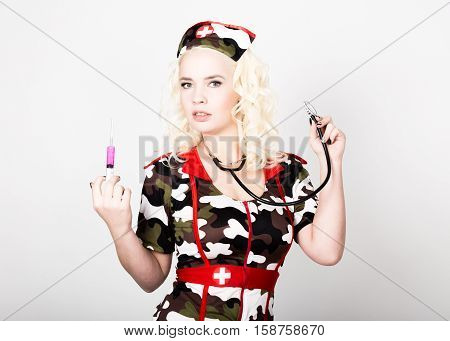 young beautiful woman dressed as a miliyary nurse, medical carnival costume.