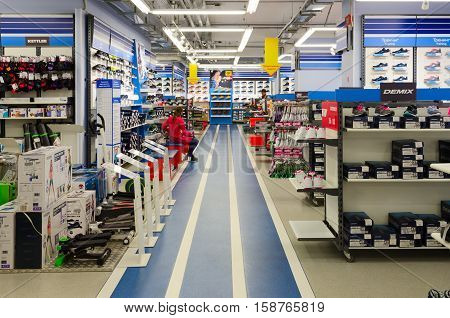 MOGILEV BELARUS - SEPTEMBER 28 2016: Unknown girl tries on sneakers in store of sporting goods 