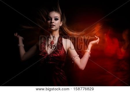Girl in a red dress on a fire