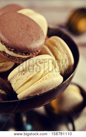 Brown and beige macaroon on a wooden background. Selective focus.