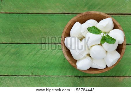 Mini mozzarella cheese in a wooden bowl