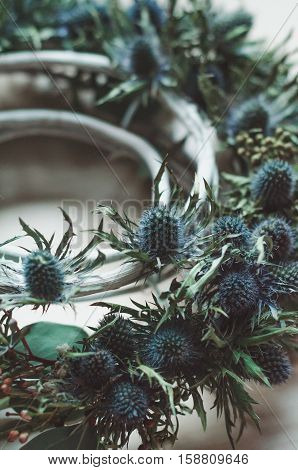 Abstract winter background. Floral wreath rustic style christmas still life. Flowers decor made. Toned close up. Text place