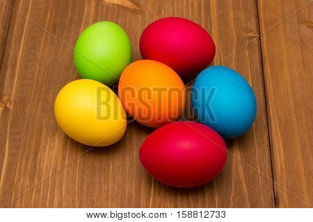 colorful easter eggs on wood brown background