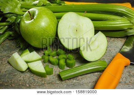 Green vegetables and fruits - celery shoots and apples healthy fitness diet concept