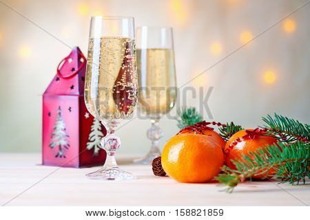Mandarins, champagne, fir-tree branch and house shaped candlestick