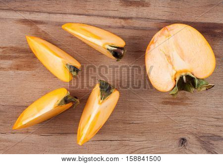 Ripe fresh persimmon on wood board. Food ingredient. Fruits