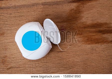Dental floss isolated on wood desk. Dental care