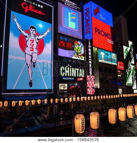 Osaka - July 2016: Famous Glico running man billboard glowing at night . Dotonbori