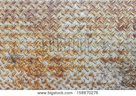 Steel floor for background or texture. Front view of a rusty panel with non-slip surface.
