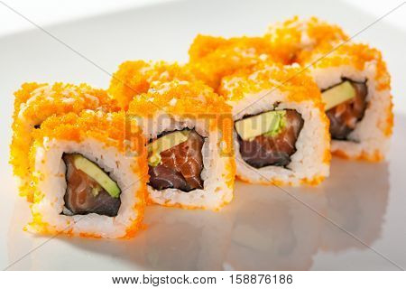 Maki Sushi with Masago  - Roll made of Fresh Raw Salmon, Avocado inside. Masago (smelt roe) outside