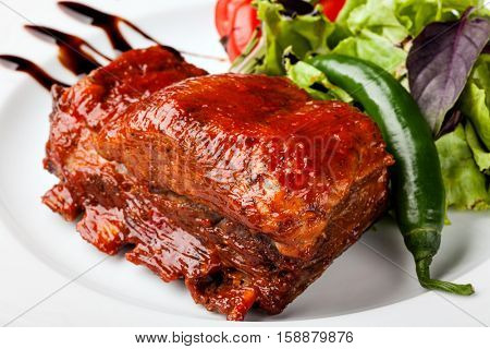 roasted pork ribs on a white plare