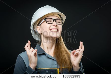 portrait of a young female worker on the black background