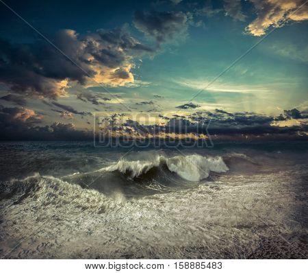 View of great storm on the sea. Strong wind and big waves with splash drops under dark sky.