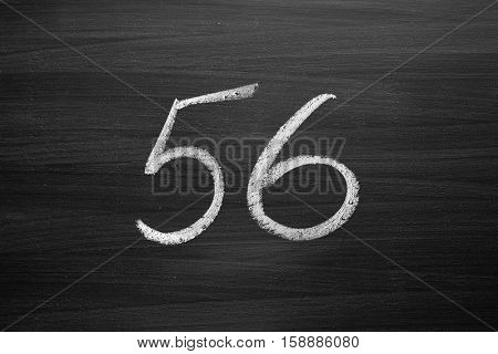 number fifty six enumeration written with a chalk on the blackboard
