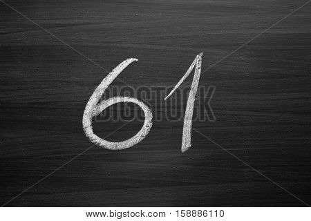 number sixty one enumeration written with a chalk on the blackboard