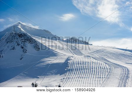 Alpine winter mountain landscape. French Alps covered with snow in sunny day. Val-d'Isere, France
