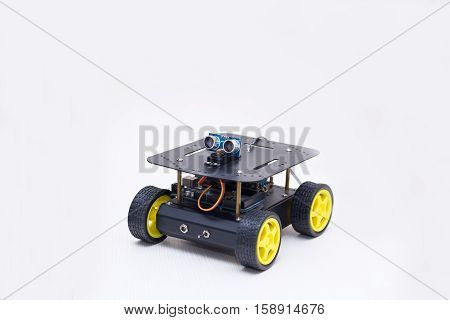 metal robot on wheels on white background