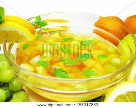 fruit cruchon cocktail punch in bowl with ice and fruit