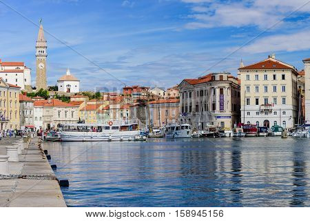 Piran, Slovenia - September 19, 2016: a view of the city of Piran with beautiful old buildings and boats in the Harbor. Piran is one of Slovenia's major tourist attractions.