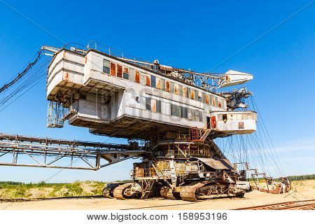multi bucket excavator, giant stacker, absetzer in career. red water rich in minerals