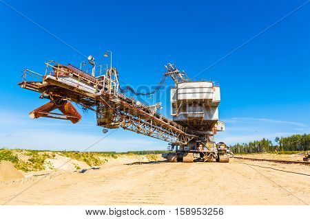 multi bucket excavator, giant stacker, absetzer in career. red water rich in minerals