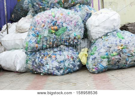 Illustrative image. Pondicherry, Tamil Nadu, India - March 03, 2014. Household waste pastic pick up in the village. Women workers Plastic bottles, papers, bin