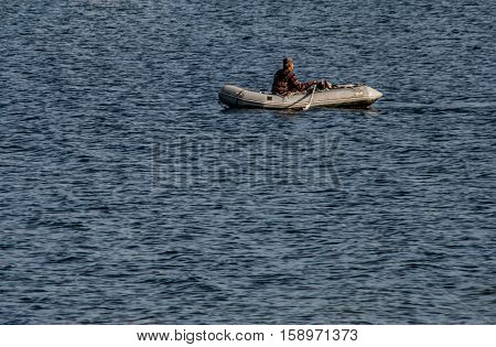 Man, and a Dingy is a photograph about a lone seafarer in his rubber raft in the ocean where he depends completely on his own abilities to survive.