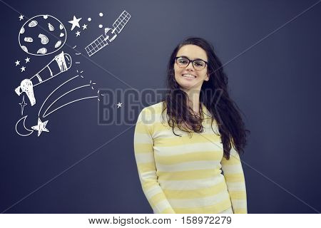 Young smiling woman on blue gray background with universum icons. Confusion.
