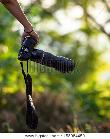 Travaler woman hand holding camera, select focus