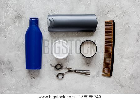 mens cosmetics for hair in bottle at gray background top view