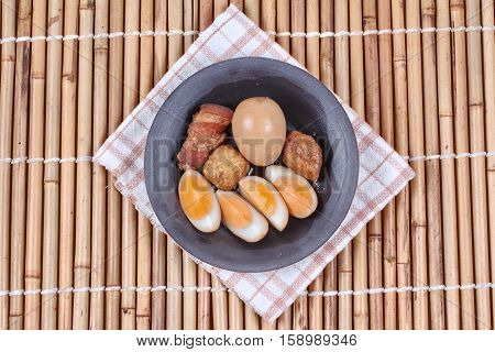 Ready stewed boiled egg with tofu and streaky pork served as Khai Phalo in Thai.