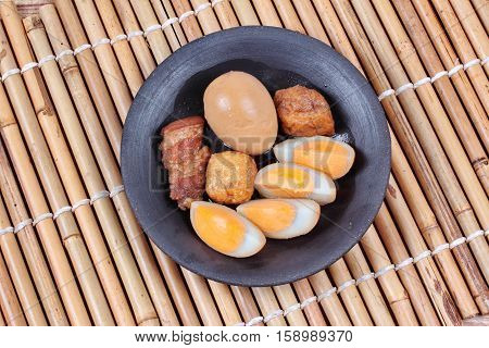Ready stewed boiled egg with tofu and streaky pork served as Khai Phalo in Thai.