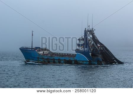 New Bedford, Massachusetts, USA, - September 11, 2018: Commercial fishing vessel Sea Watcher I heading out into the fog on Buzzards Bay