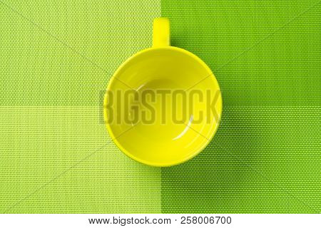 Green Kitchen Backdrop With Empty Yellow Cup.