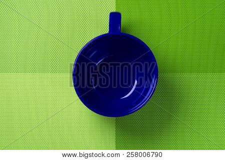 Green Kitchen Backdrop With Empty Blue Cup.