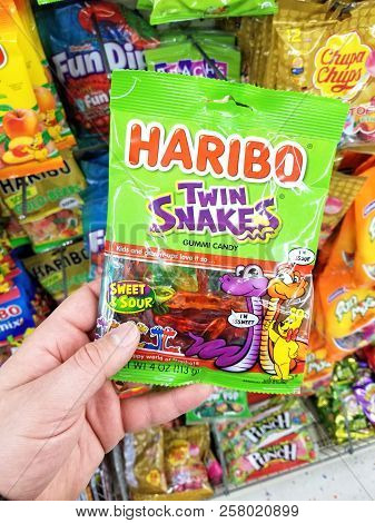 Plattsburgh, Usa - September 10, 2018: A Man Holding Haribo Twin Snakes Pack. Haribo Is A German Con