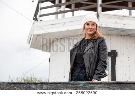 Portrait  Outdoor Atmospheric Lifestyle Photo Of Young Beautiful  Darkhaired Woman  In Knitting Hat,