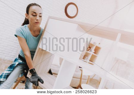 Young Couple Assembling Wooden Bookshelf At Home. Wooden Bookcase. Selfmade Furniture. Family At Hom