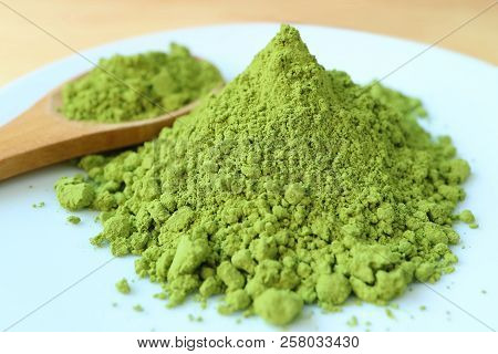 Close Up Of Vibrant Green Color Matcha Tea Powder, Ingredient For Making Hot Green Tea With Blurred 