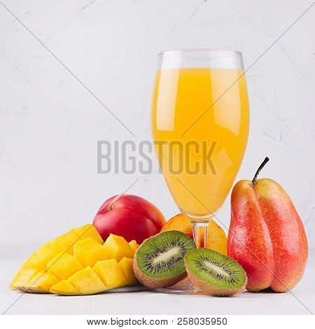 Multi Fruit Tropical Juice In Elegant Glass With Different Fruits On White Wood Board, Square.