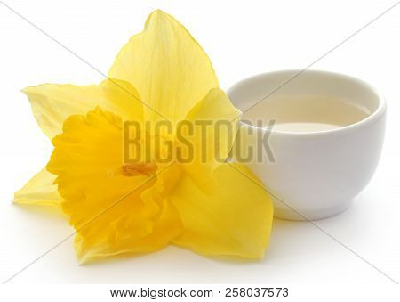 Flower Daffodil With Extract In A Bowl Over White Background