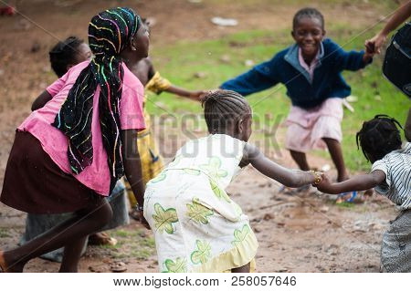 Mali, Africa - Circa August 2009 -   Black African Children Enjoy Life Hacing A Round Dance In A Rur