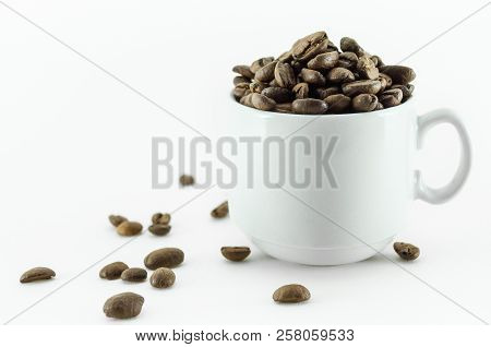 Coffee Bean - Small Cup Full Of Coffee Bean Isolated On White.